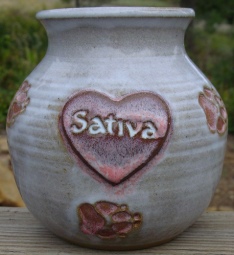 white and pink pet urn