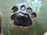 green and black glazed paw prints